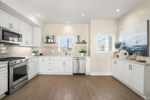 a kitchen with appliances a sink and a cabinets