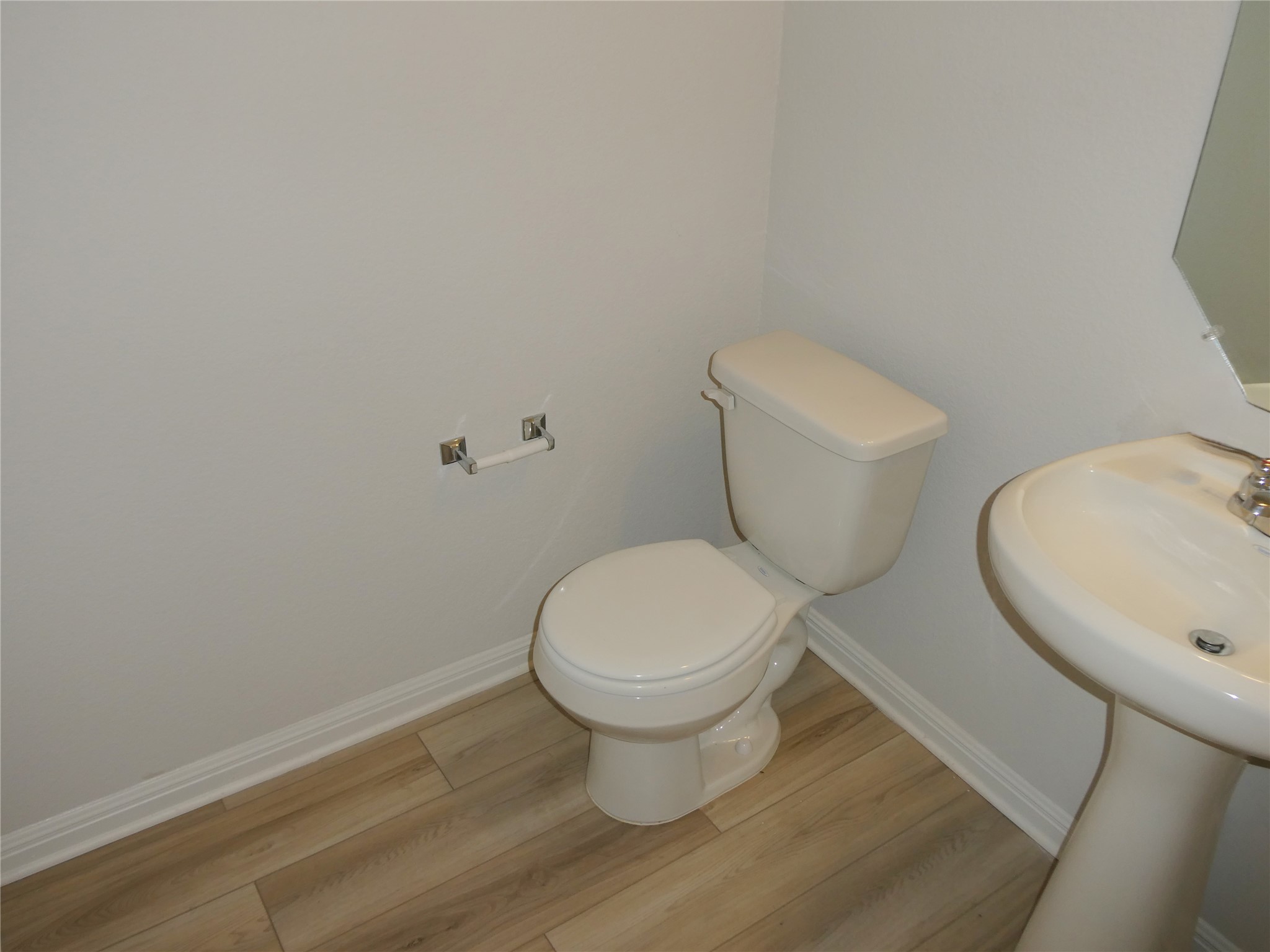 10906 Sentinel Drive Austin, TX 78747 - Photo 15 of 18 a white toilet sitting next to a white sink and a granite countertops