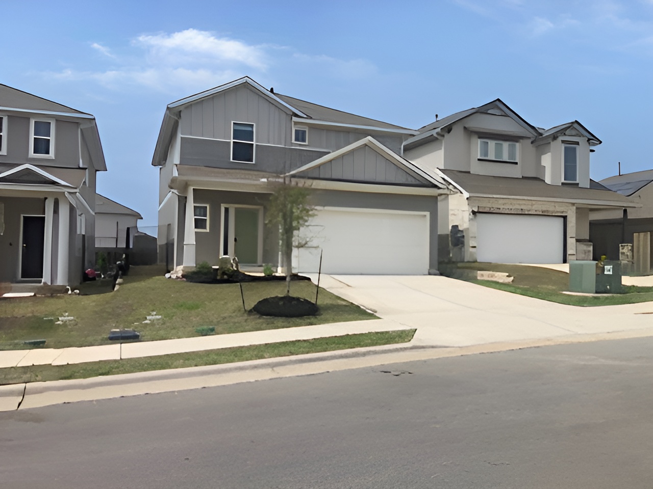 10906 Sentinel Drive Austin, TX 78747 - Photo 2 of 18 a front view of a house with a yard