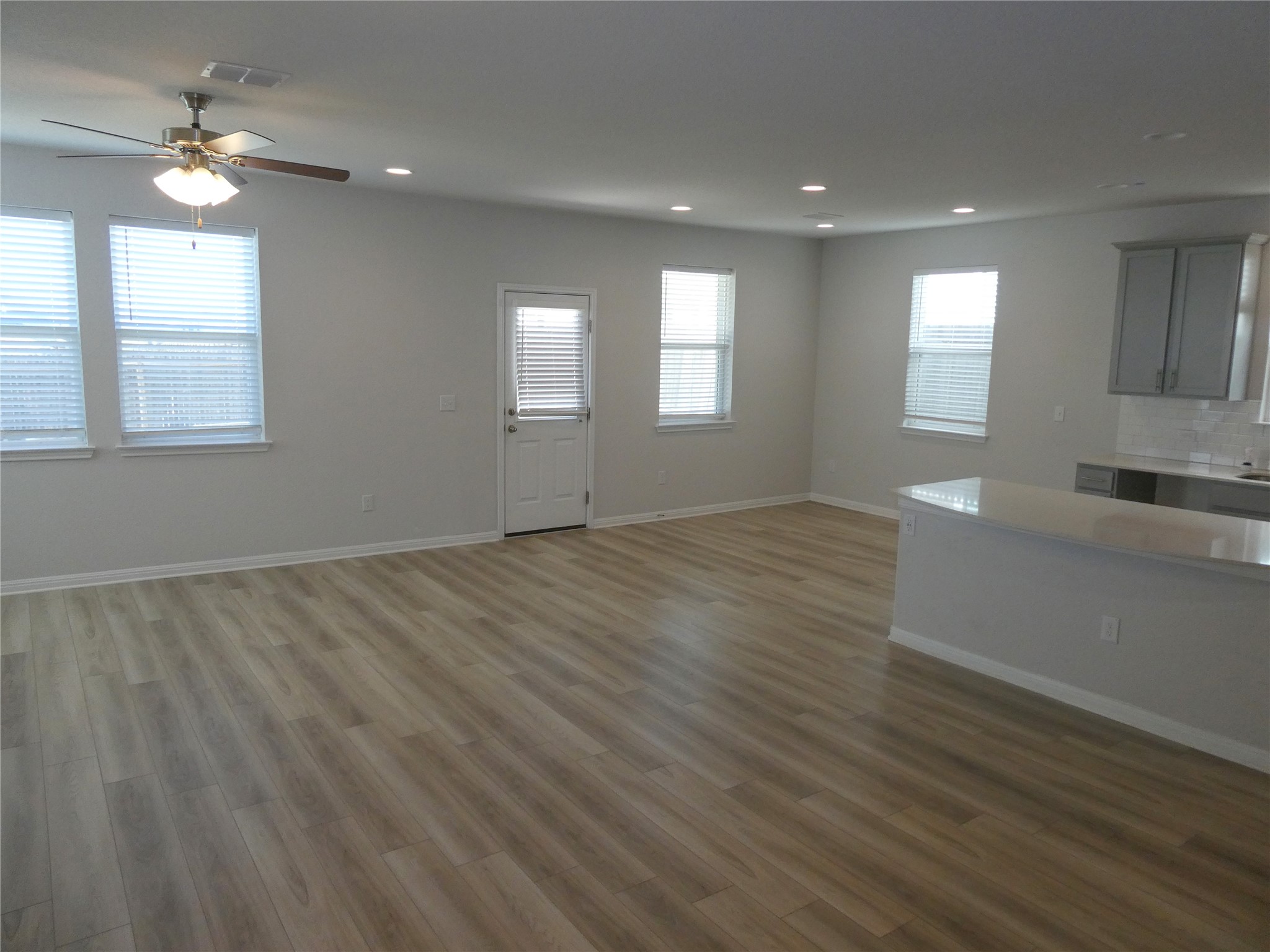 10906 Sentinel Drive Austin, TX 78747 - Photo 4 of 18 a view of empty room with wooden floor and fan