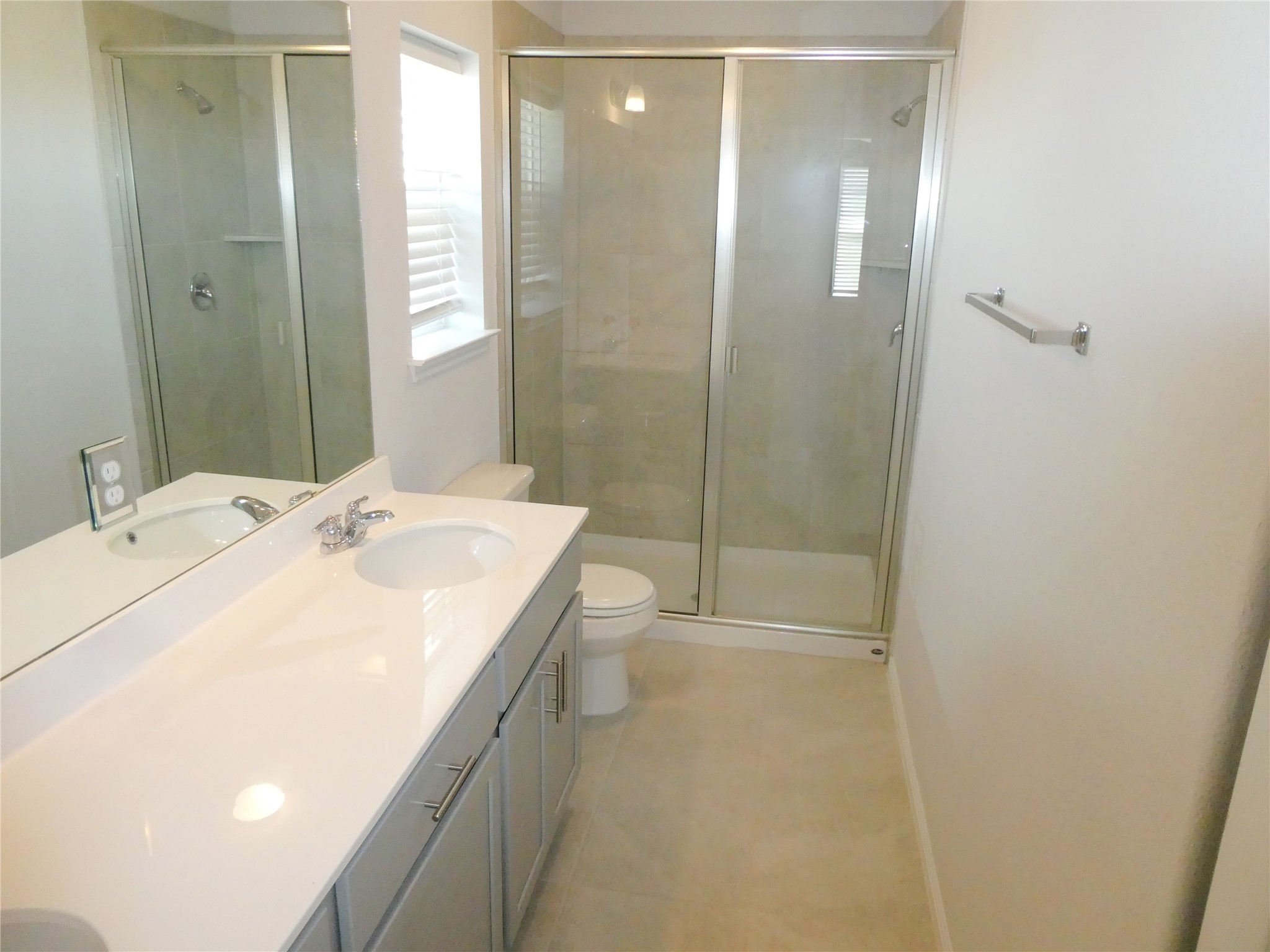 10906 Sentinel Drive Austin, TX 78747 - Photo 10 of 18 a bathroom with a sink a toilet and shower