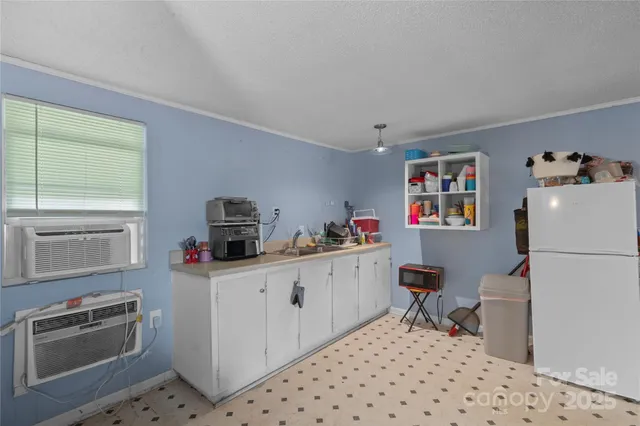 a kitchen with a refrigerator and a stove top oven