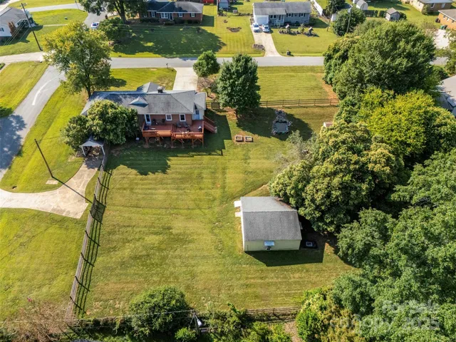 a aerial view of a house with a yard swimming pool and outdoor seating