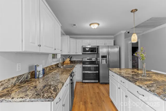 a kitchen with refrigerator and stove