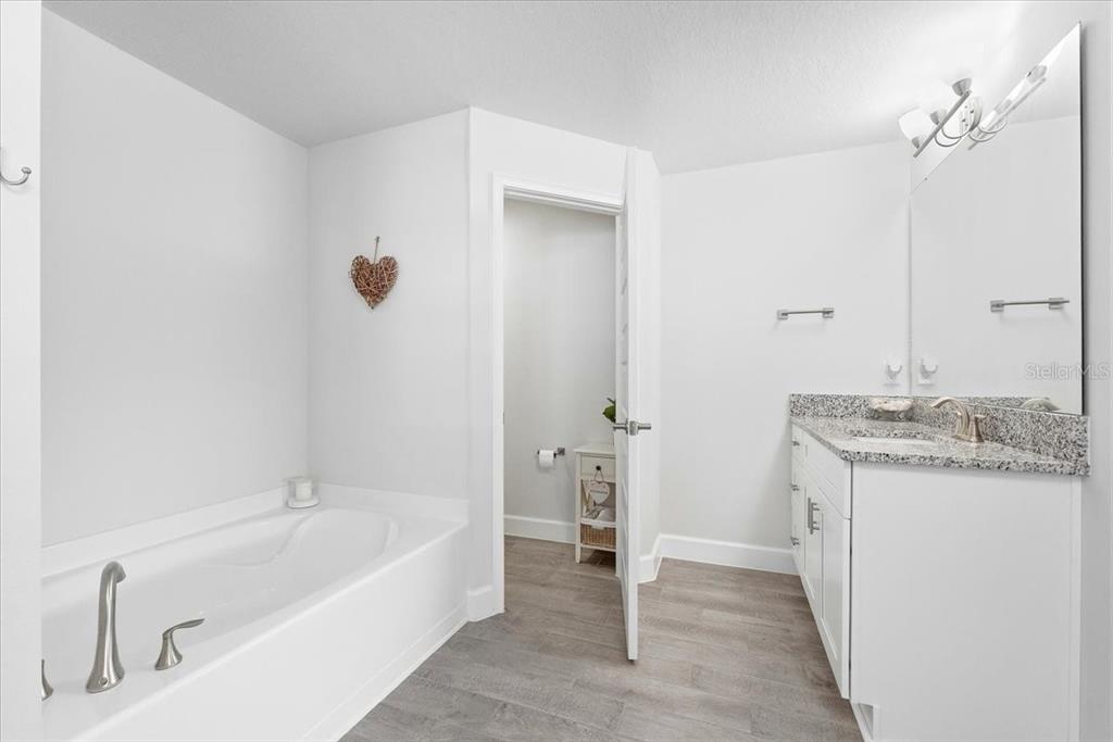 331 Cres Ridge Road Auburndale, FL 33823 - Photo 39 of 63 a bathroom with a granite countertop sink and a mirror