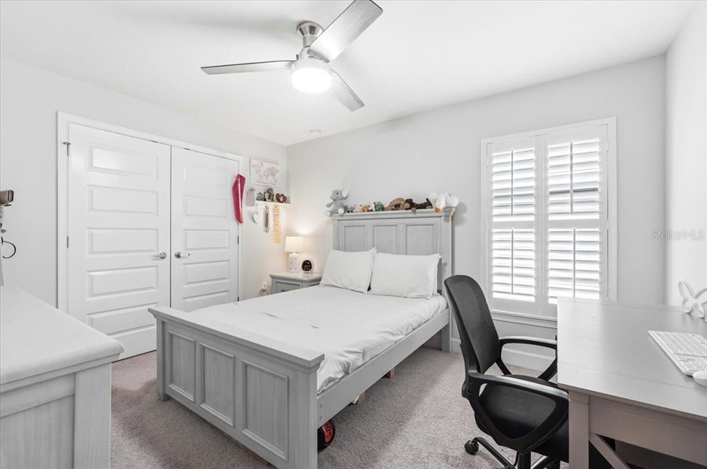 331 Cres Ridge Road Auburndale, FL 33823 - Photo 51 of 63 a bedroom with a bed a desk and chair with the wooden floor