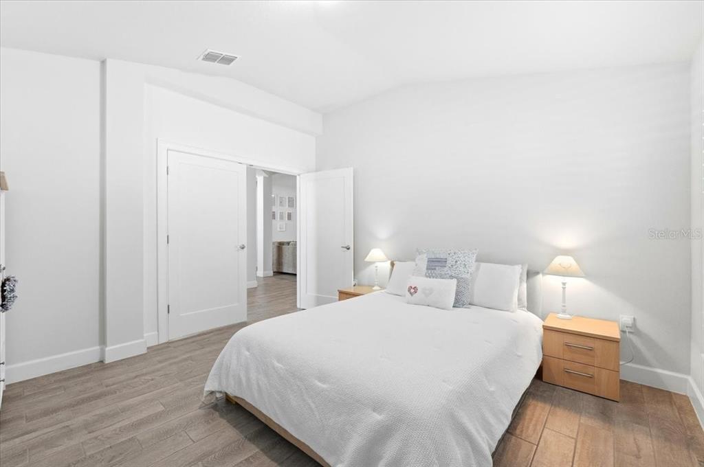 331 Cres Ridge Road Auburndale, FL 33823 - Photo 55 of 63 a bedroom with a bed and wooden floor