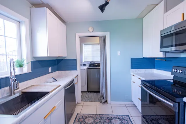 a kitchen that has a sink and a stove in it
