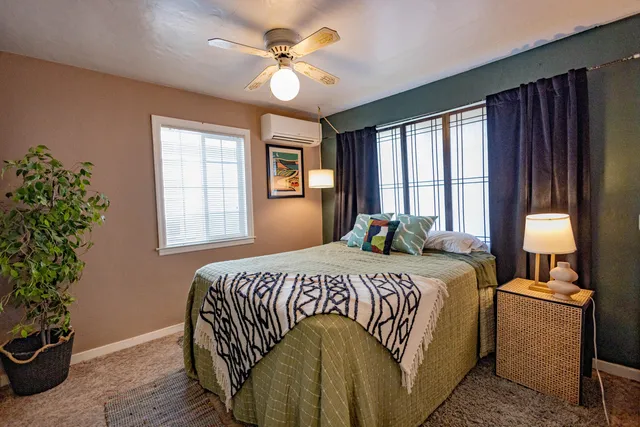 a bedroom with a bed and a window