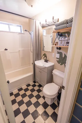 a bathroom with a toilet a sink and a shower