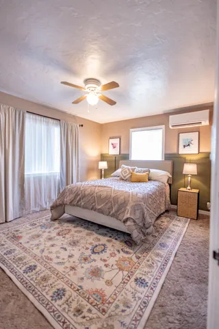 a bedroom with a large bed and a chandelier