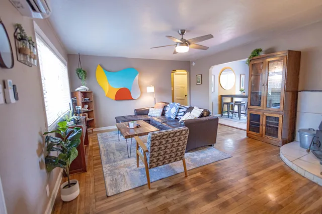 a living room with furniture and a chandelier