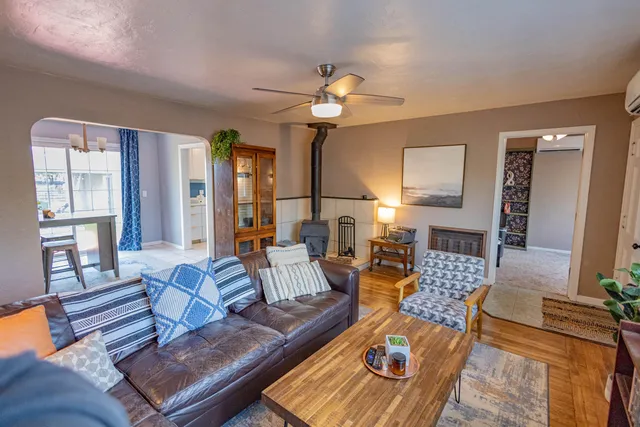 a living room with furniture a rug and a chandelier