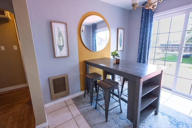 a view of a dining room with furniture and a mirror