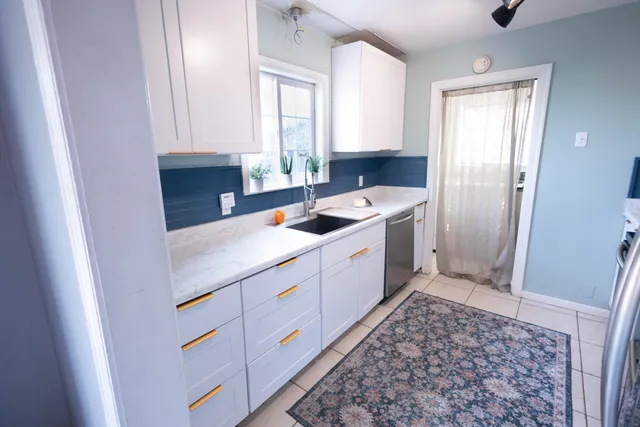 a kitchen with sink cabinets and window