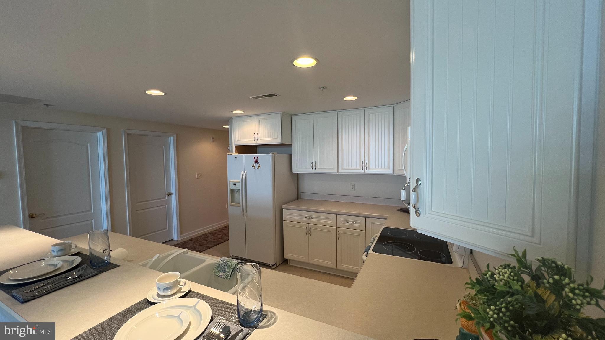 103 Williams Street, Unit 416 Crisfield, MD 21817 - Photo 13 of 38 a kitchen with a refrigerator and a stove