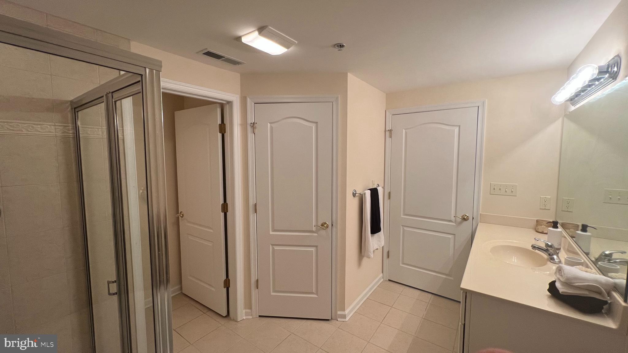 103 Williams Street, Unit 416 Crisfield, MD 21817 - Photo 20 of 38 a bathroom with a sink and mirror