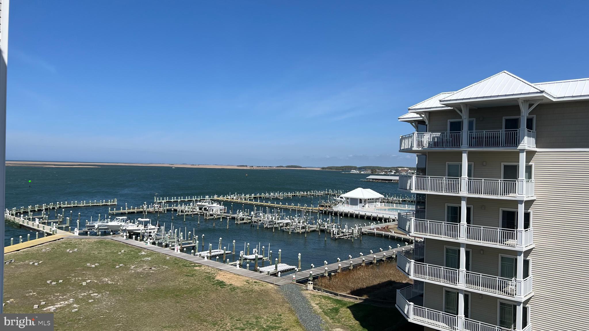 103 Williams Street, Unit 416 Crisfield, MD 21817 - Photo 2 of 38 a view of a lake with a building in front of it