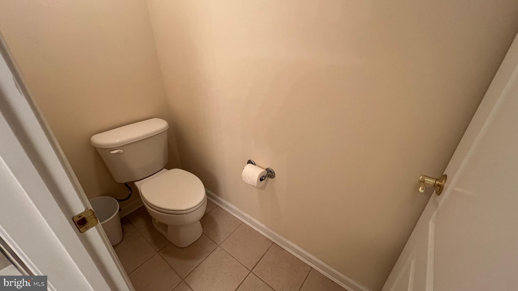 103 Williams Street, Unit 416 Crisfield, MD 21817 - Photo 22 of 38 a white toilet sitting next to a white sink