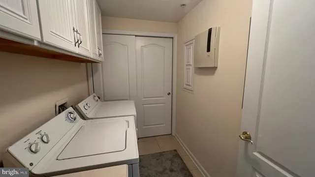 a hallway with a glass door and a bathroom