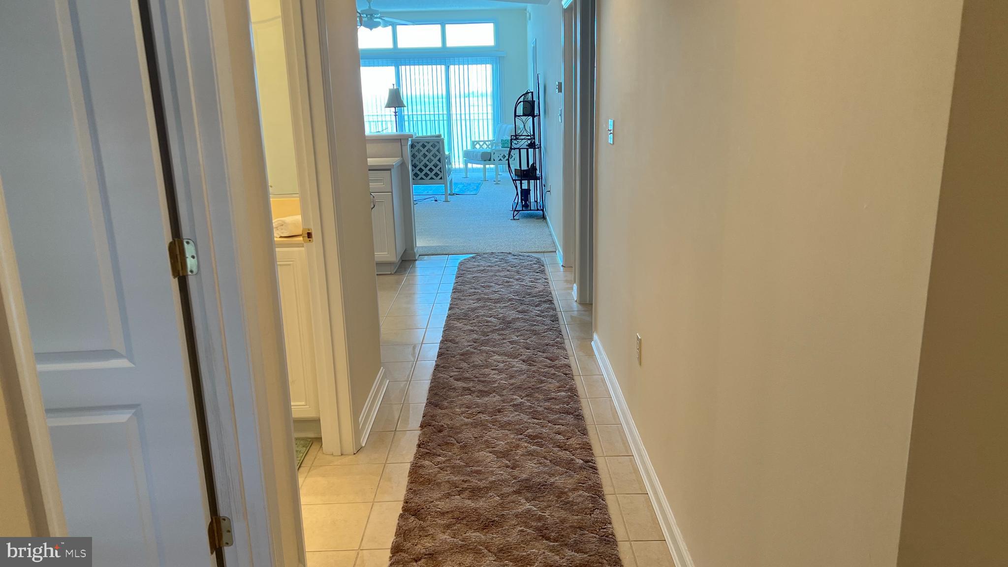 103 Williams Street, Unit 416 Crisfield, MD 21817 - Photo 24 of 38 a hallway with a glass door and a bathroom