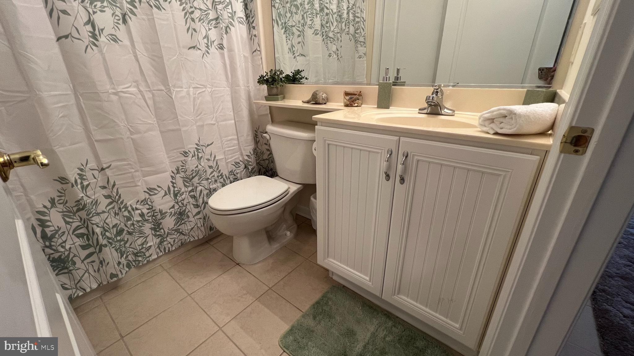 103 Williams Street, Unit 416 Crisfield, MD 21817 - Photo 30 of 38 a bathroom with a sink toilet and shower