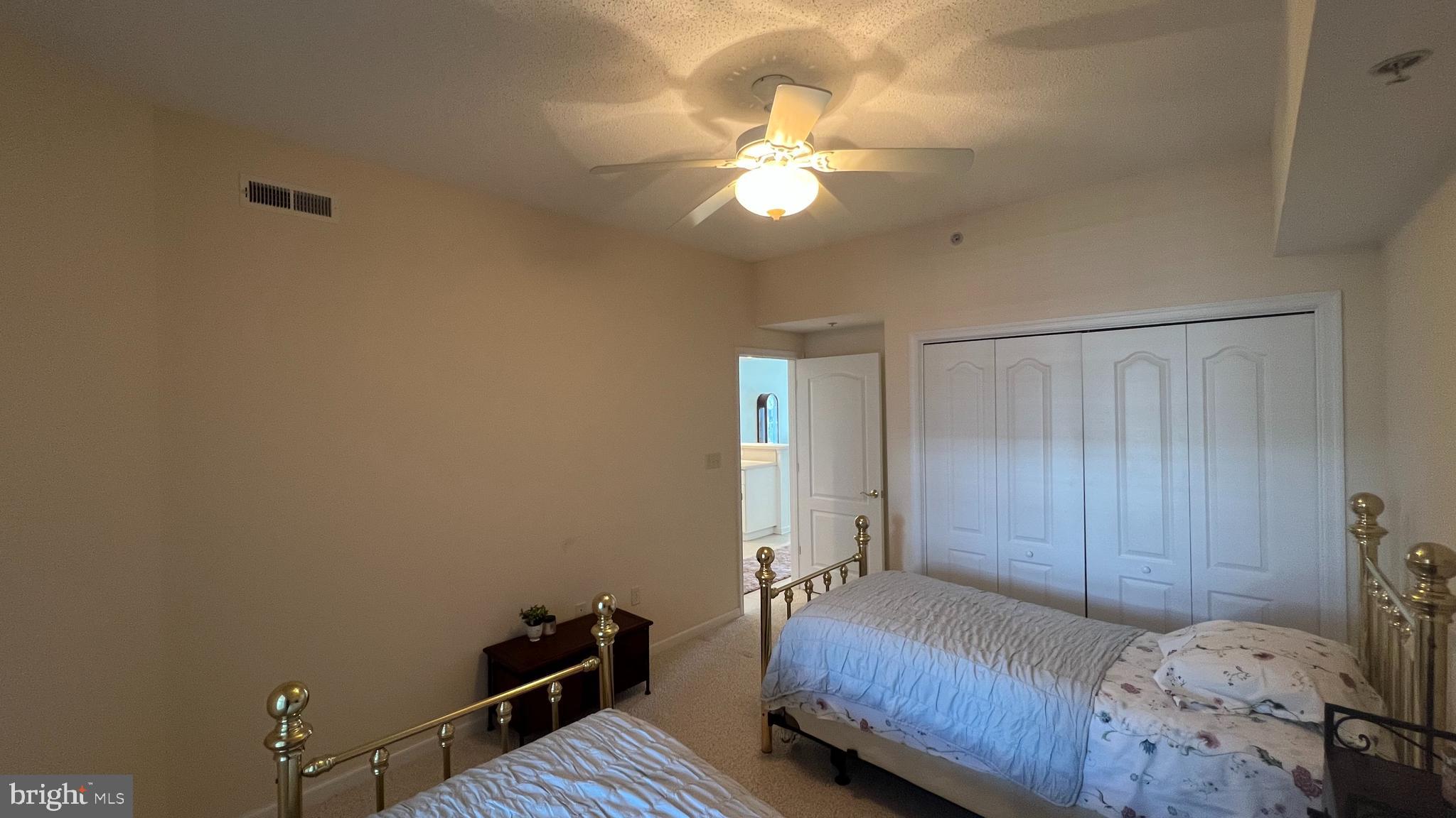103 Williams Street, Unit 416 Crisfield, MD 21817 - Photo 32 of 38 a bedroom with a bed and a chandelier