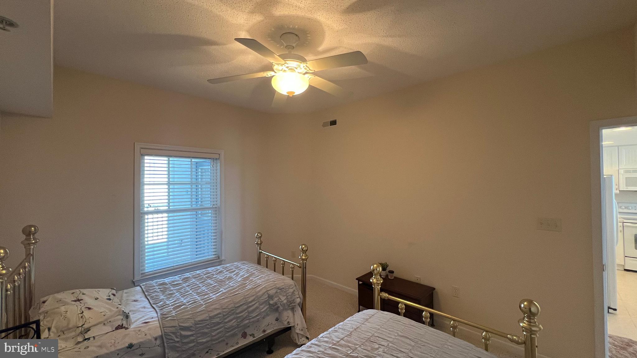 103 Williams Street, Unit 416 Crisfield, MD 21817 - Photo 33 of 38 a bedroom with a bed and a chandelier