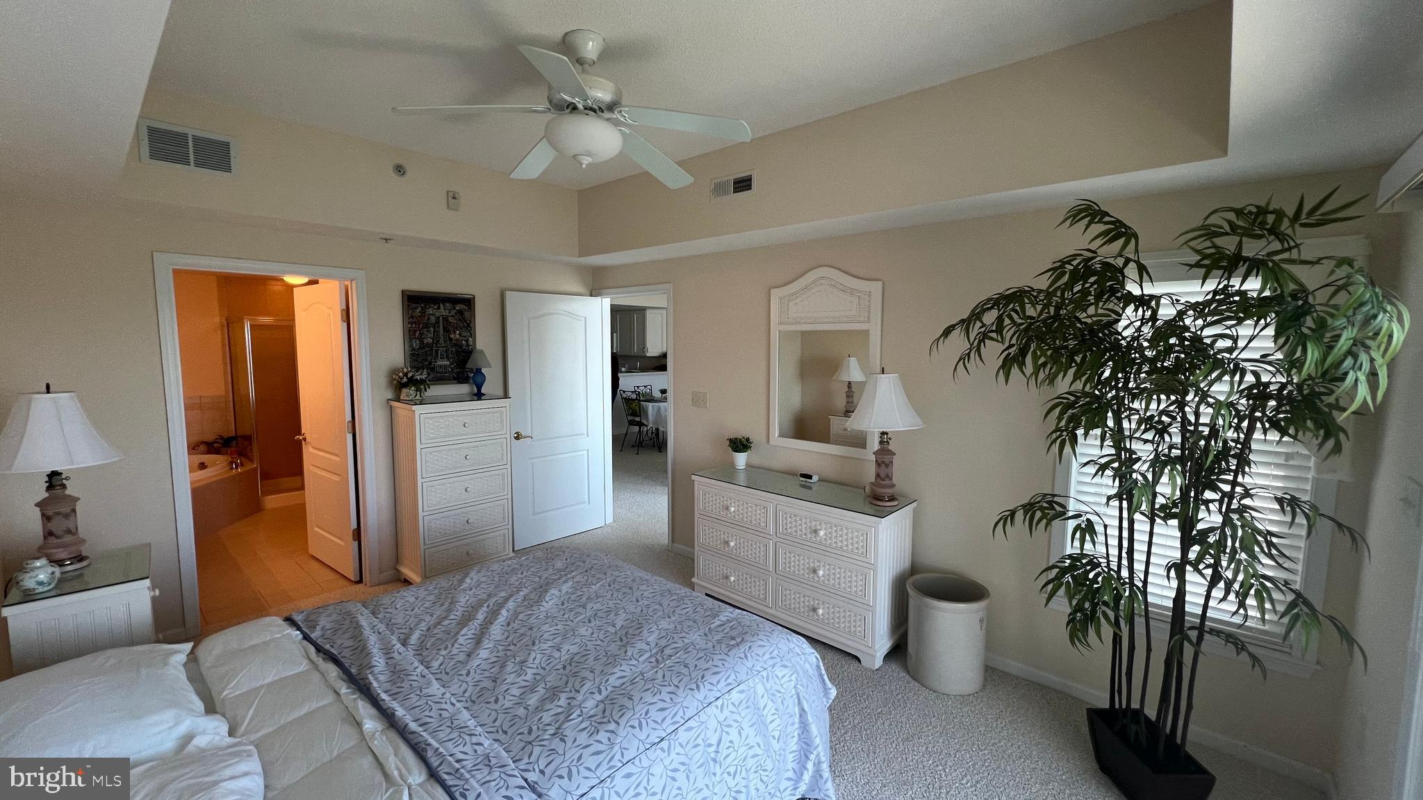 103 Williams Street, Unit 416 Crisfield, MD 21817 - Photo 5 of 38 a bedroom with a bed and a chandelier