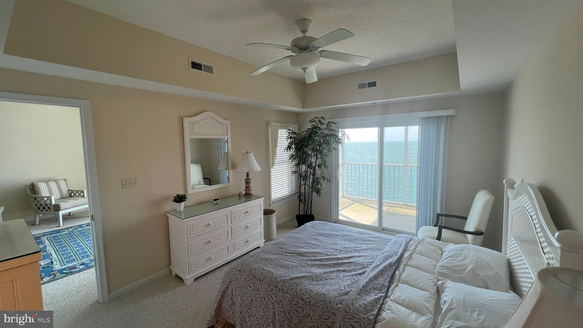 103 Williams Street, Unit 416 Crisfield, MD 21817 - Photo 6 of 38 a bedroom with a bed and a chandelier