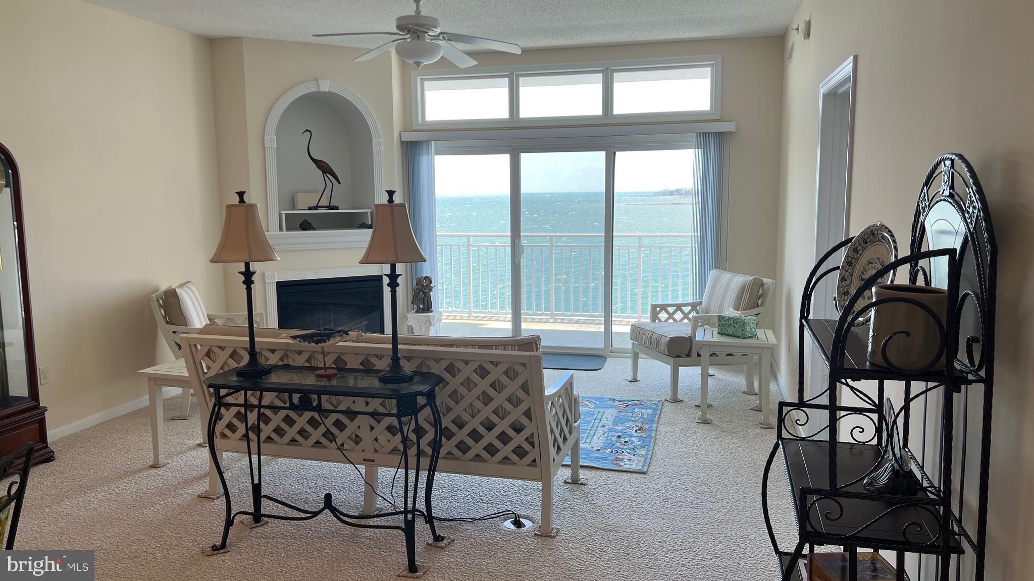 103 Williams Street, Unit 416 Crisfield, MD 21817 - Photo 10 of 38 a living room with furniture a rug and a floor to ceiling window