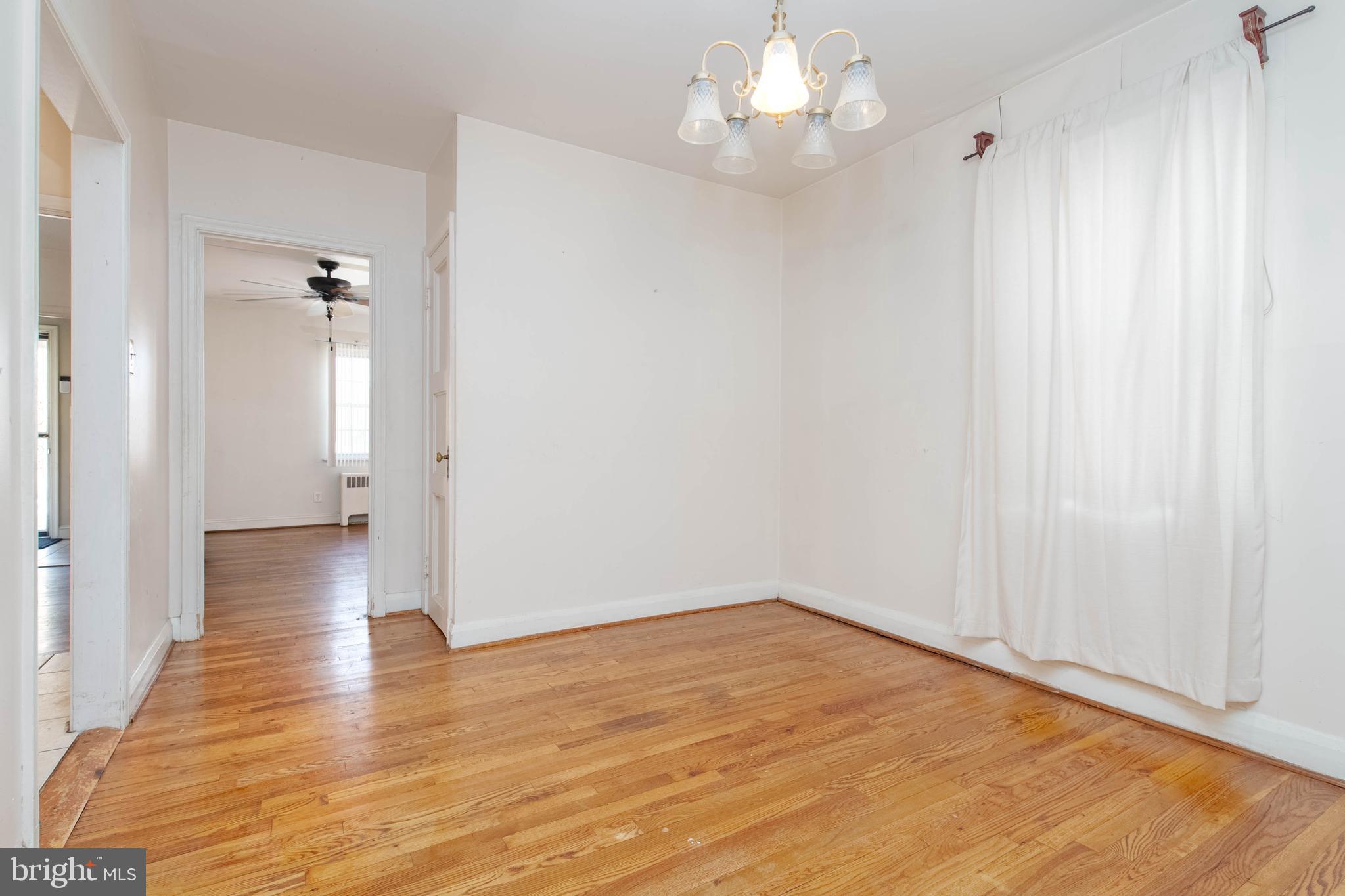 1517 North Potomac Street Baltimore, MD 21213 - Photo 15 of 44 a view of an empty room with wooden floor