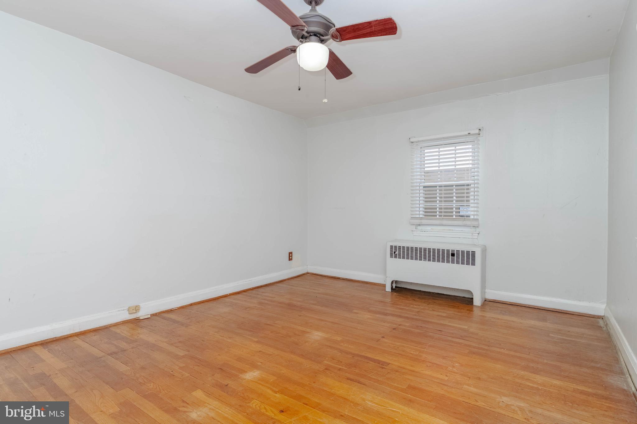 1517 North Potomac Street Baltimore, MD 21213 - Photo 16 of 44 an empty room with windows and fan