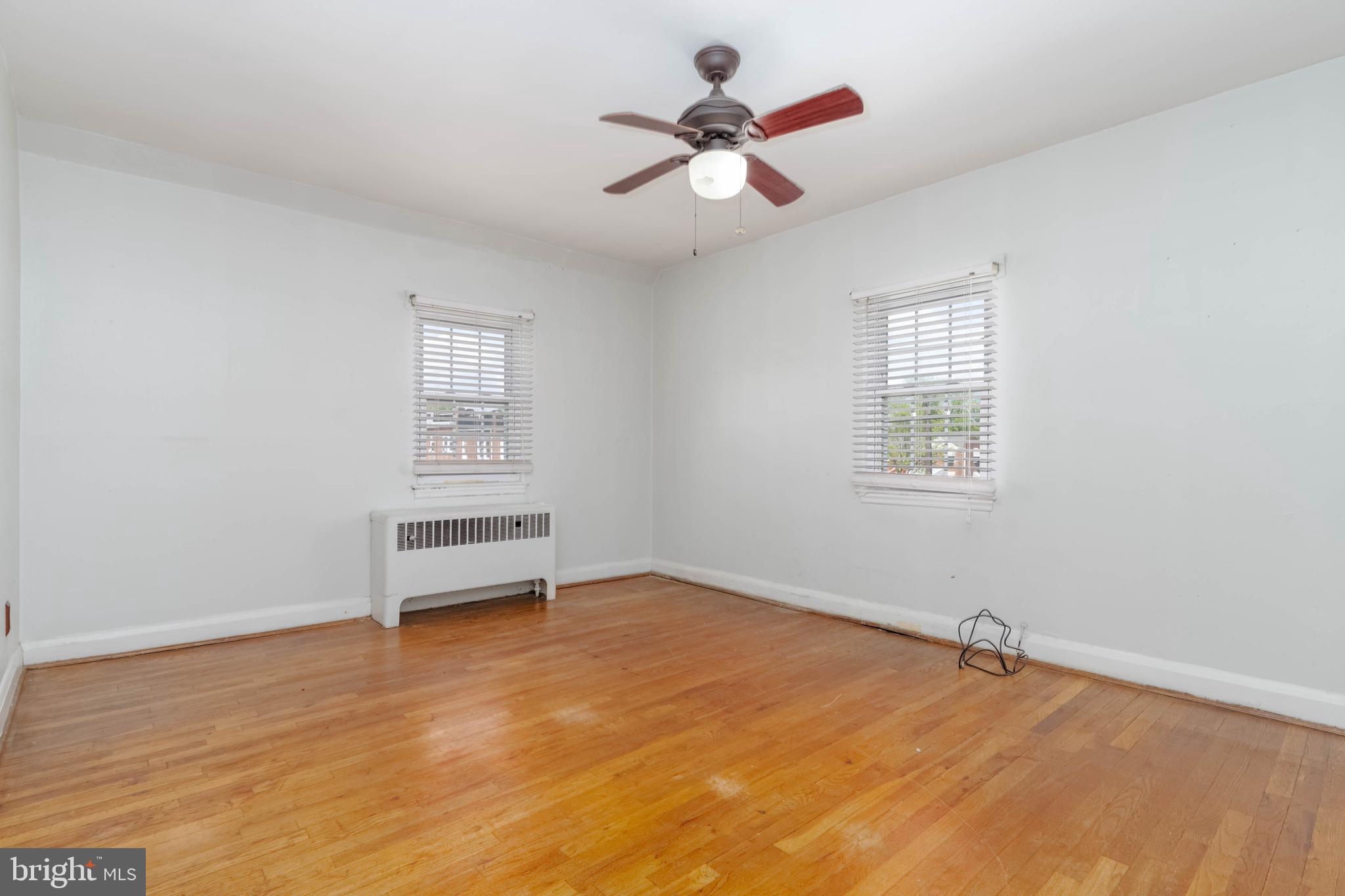 1517 North Potomac Street Baltimore, MD 21213 - Photo 17 of 44 an empty room with a window and a ceiling fan