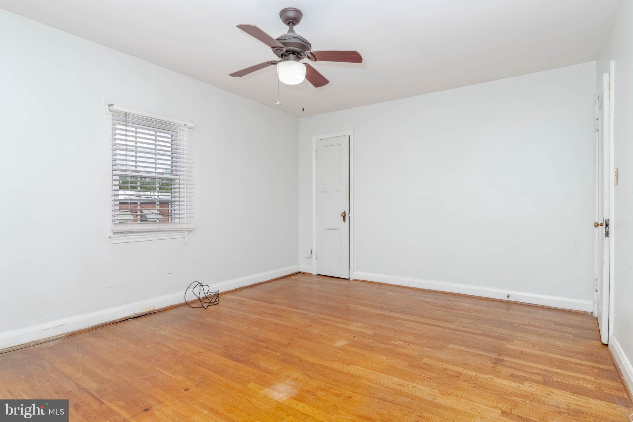 1517 North Potomac Street Baltimore, MD 21213 - Photo 18 of 44 a view of a big room with wooden floor and a chandelier fan