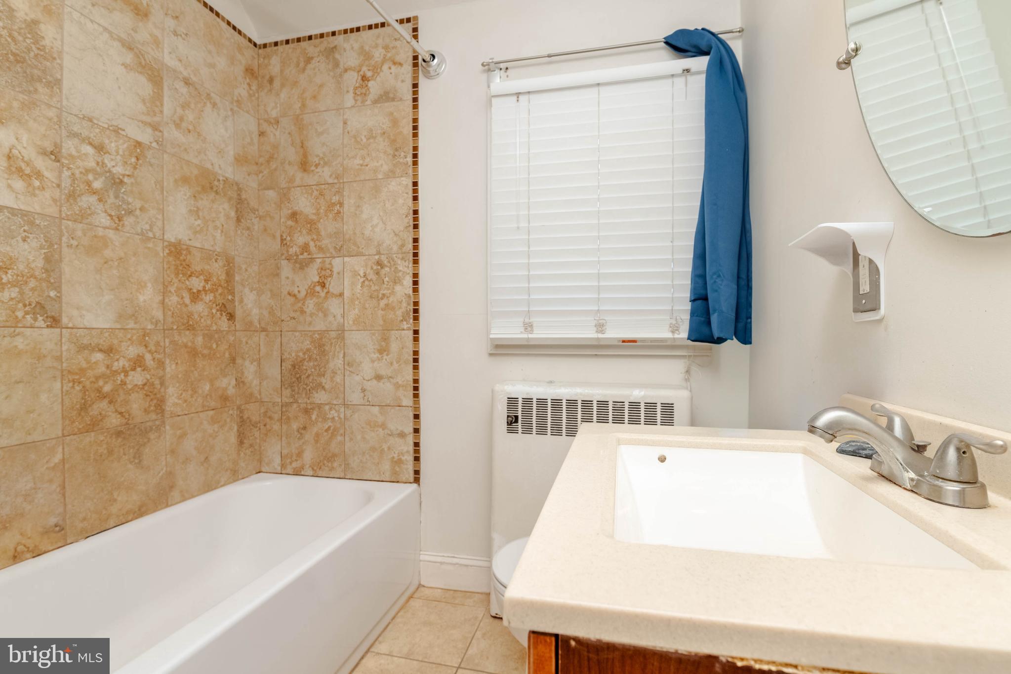 1517 North Potomac Street Baltimore, MD 21213 - Photo 28 of 44 a bathroom with a sink a bathtub and a shower
