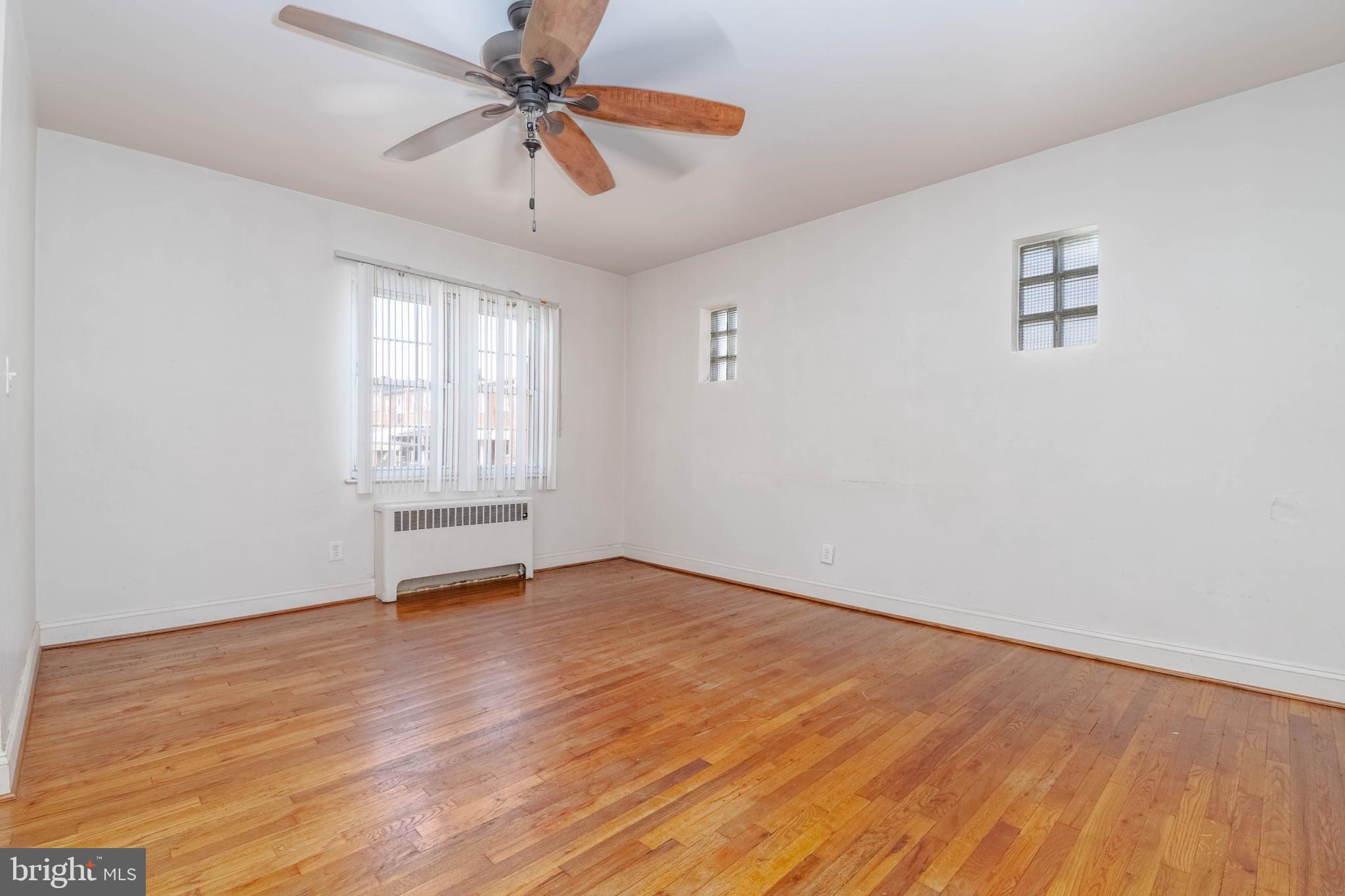 1517 North Potomac Street Baltimore, MD 21213 - Photo 6 of 44 an empty room with windows and fan