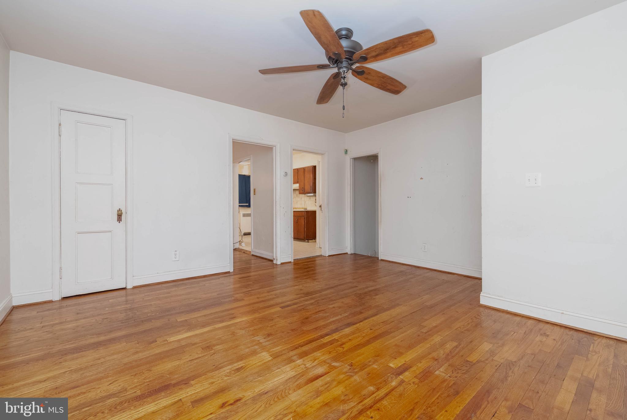 1517 North Potomac Street Baltimore, MD 21213 - Photo 7 of 44 a view of an empty room with wooden floor and a ceiling fan