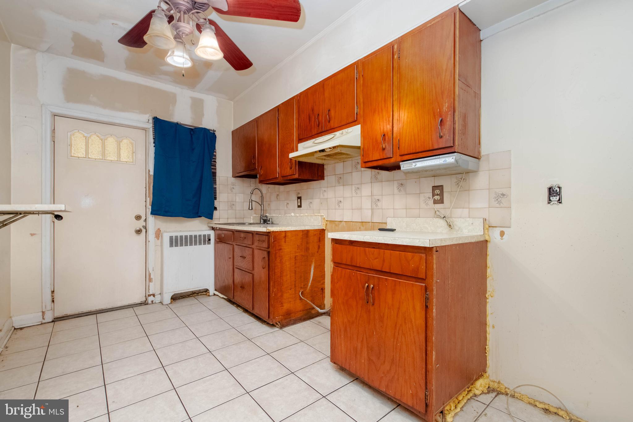 1517 North Potomac Street Baltimore, MD 21213 - Photo 10 of 44 a kitchen with stainless steel appliances granite countertop a sink a stove cabinets and entryway
