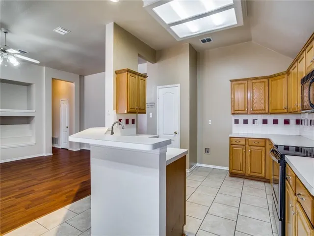 a spacious bathroom with a granite countertop sink a mirror and a bathtub