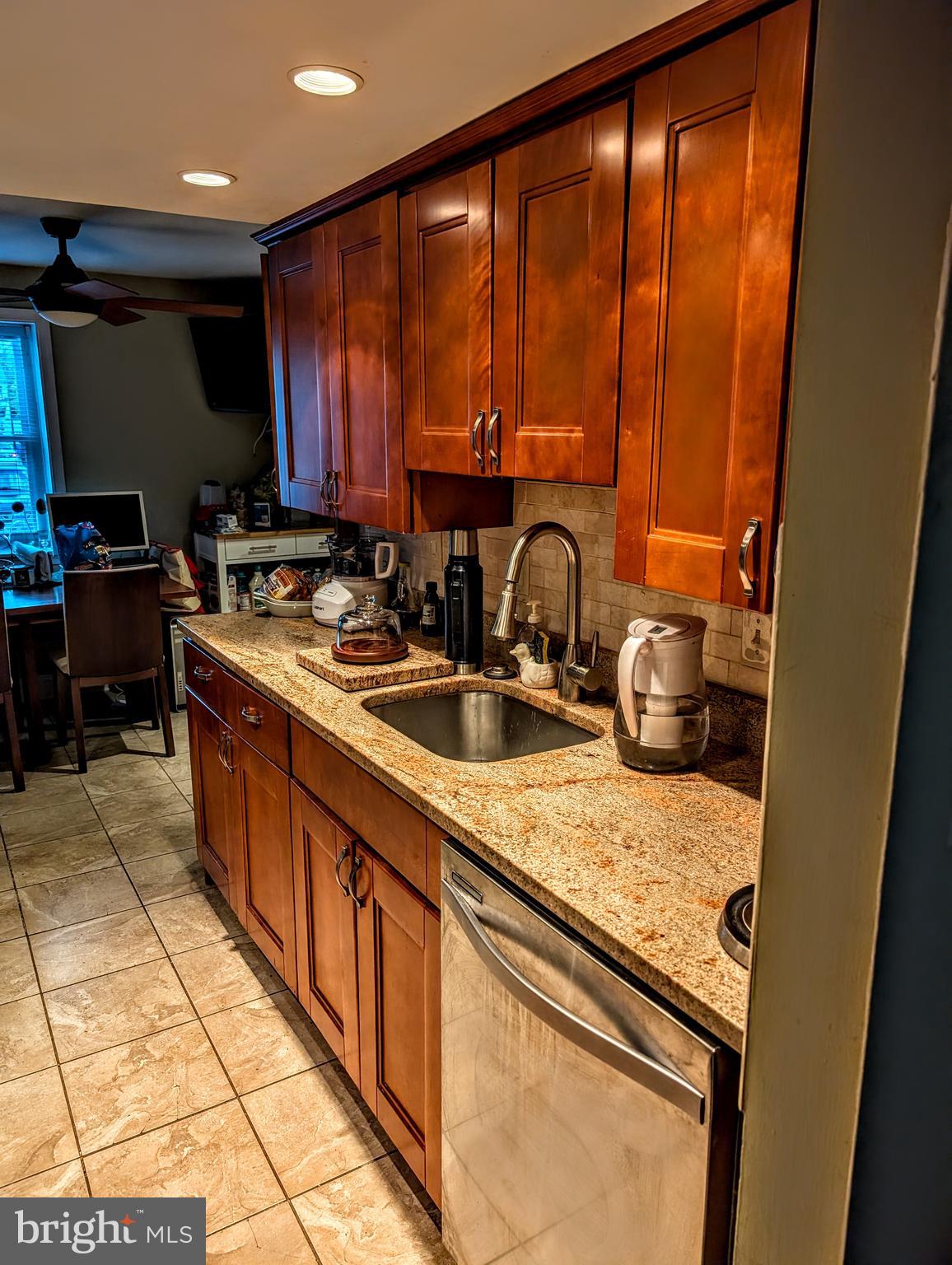 5451 Fallriver Row Court Columbia, MD 21044 - Photo 2 of 11 a kitchen with a sink a stove top oven a kitchen island a dining table and chairs