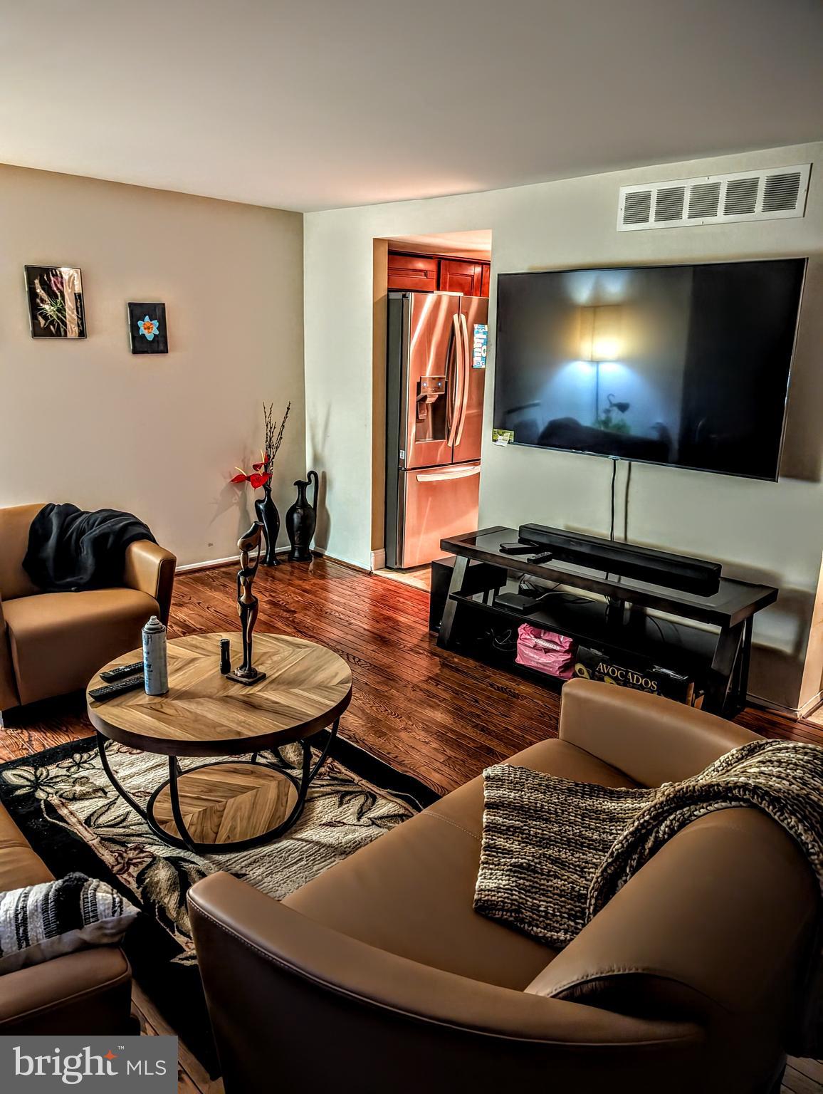 5451 Fallriver Row Court Columbia, MD 21044 - Photo 10 of 11 a living room with furniture and a flat screen tv