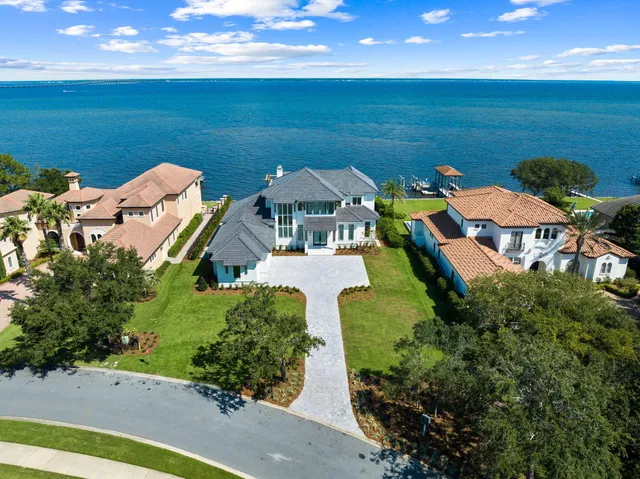 a bathroom with a granite countertop toilet sink and mirror
