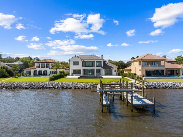 a bathroom with a shower sink vanity mirror and toilet