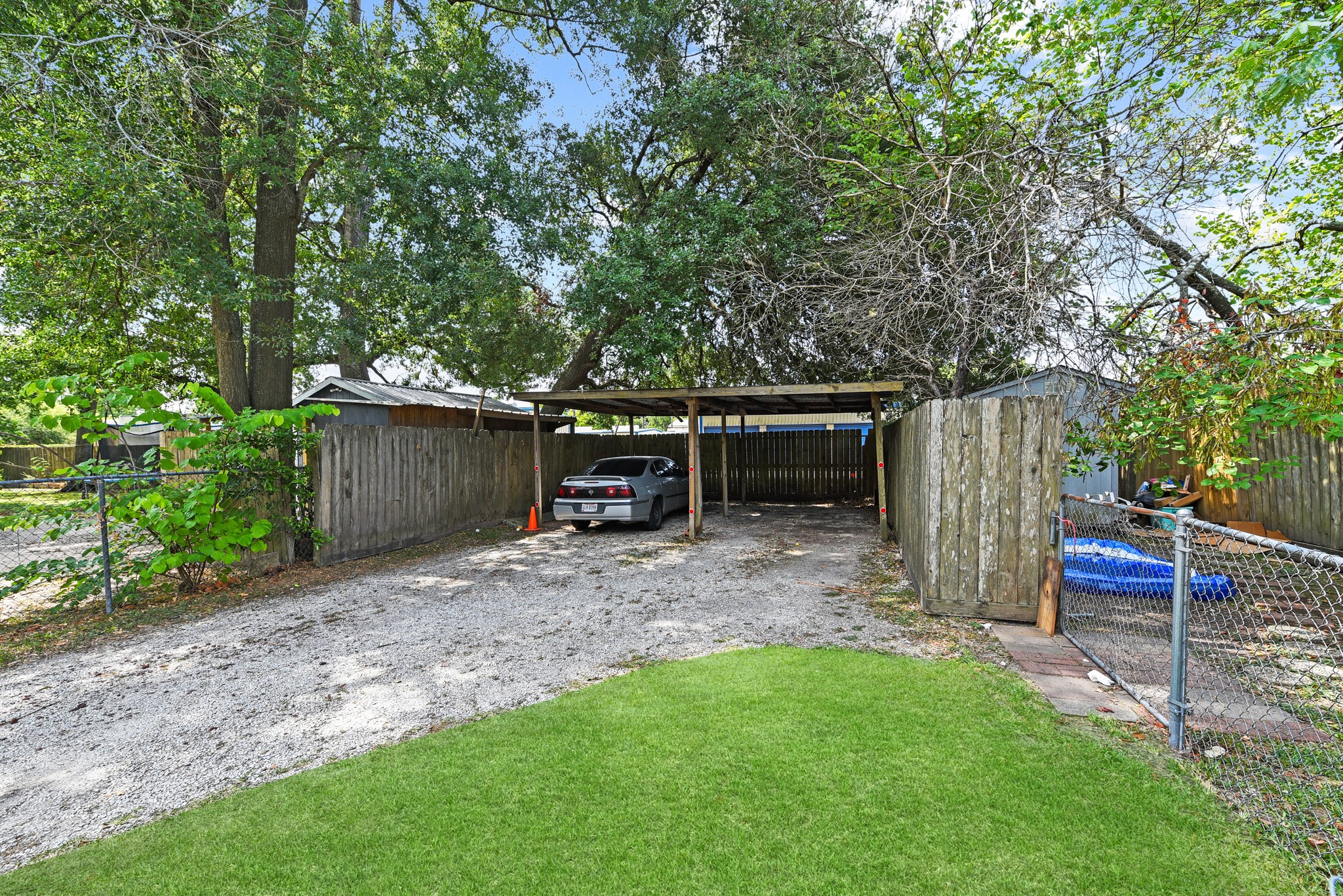 154 Willow Street Humble, TX 77338 - Photo 4 of 8 a view of a backyard with table and chairs plants and large tree
