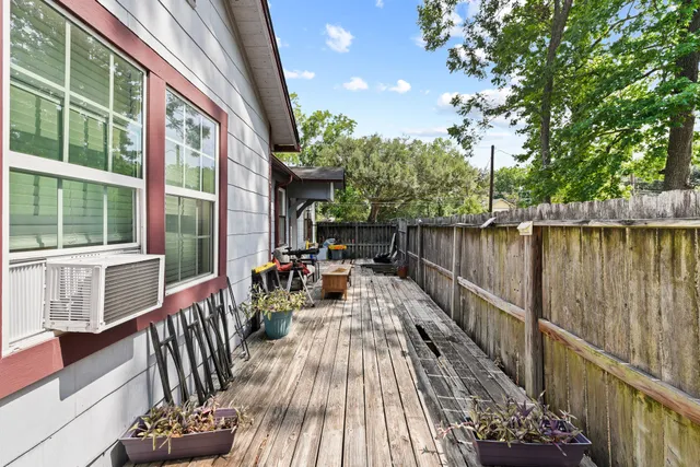 a view of balcony with chairs and wooden fence