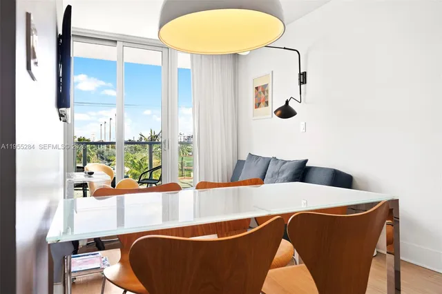 a dining room with furniture and wooden floor