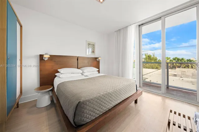 a bedroom with a bed and a large window