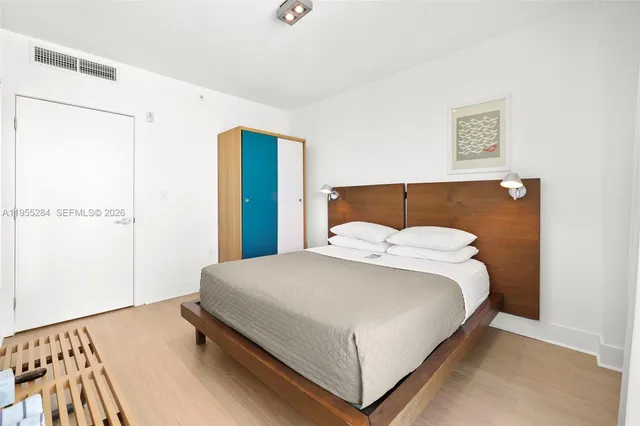 a bedroom with a bed and a night stand