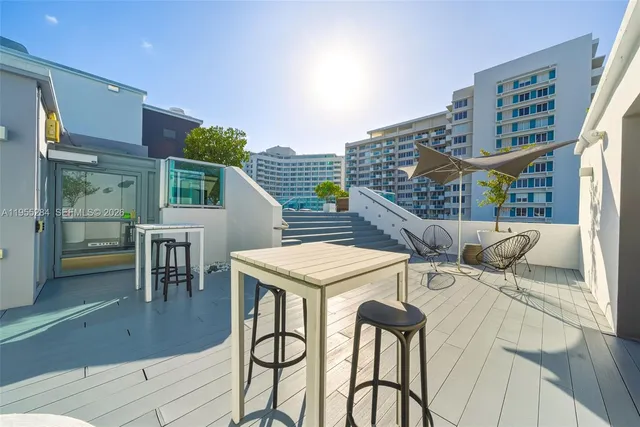 a terrace with outdoor seating and wooden floor